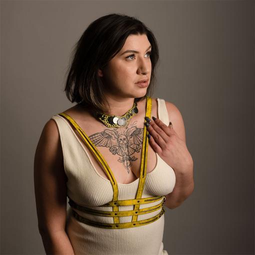 Yellow leather corset harness.